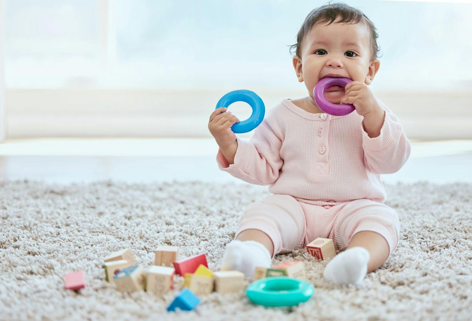 Baby,,Portrait,And,Playing,With,Toy,On,Floor,In,Home